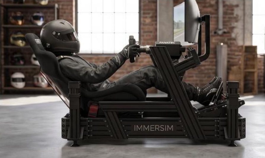 Driver in a reclined F1-style position on the IMMERSIM rig